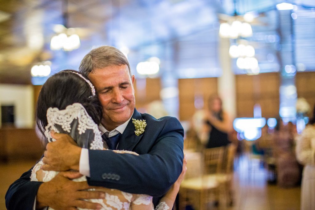 an elderly man hugging the bride