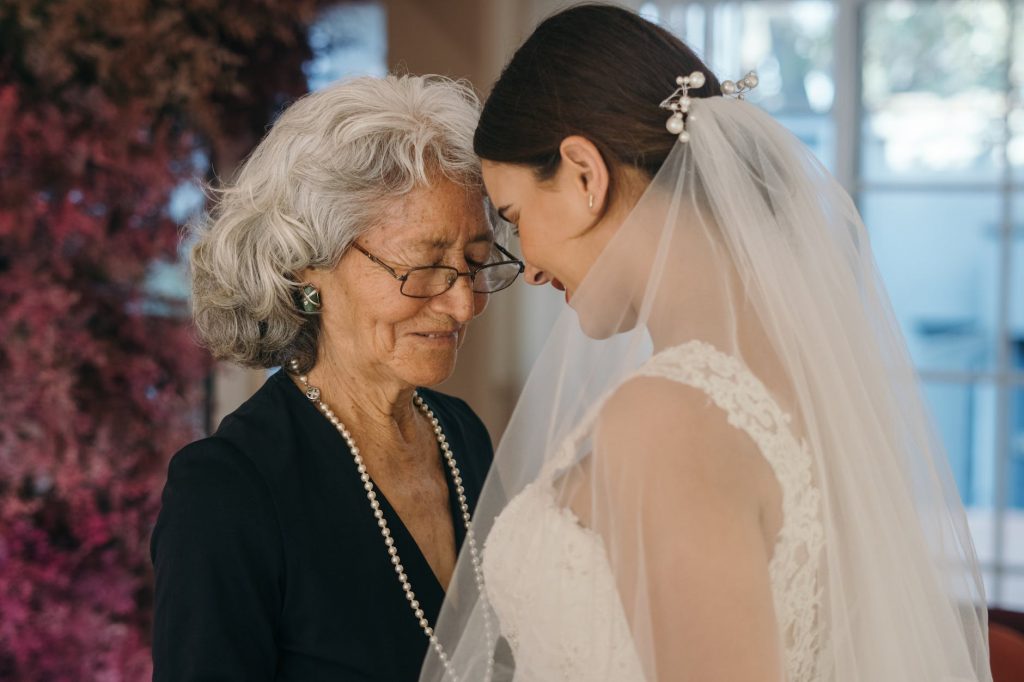 a mother and bride with their heads close together and their eyes closed
