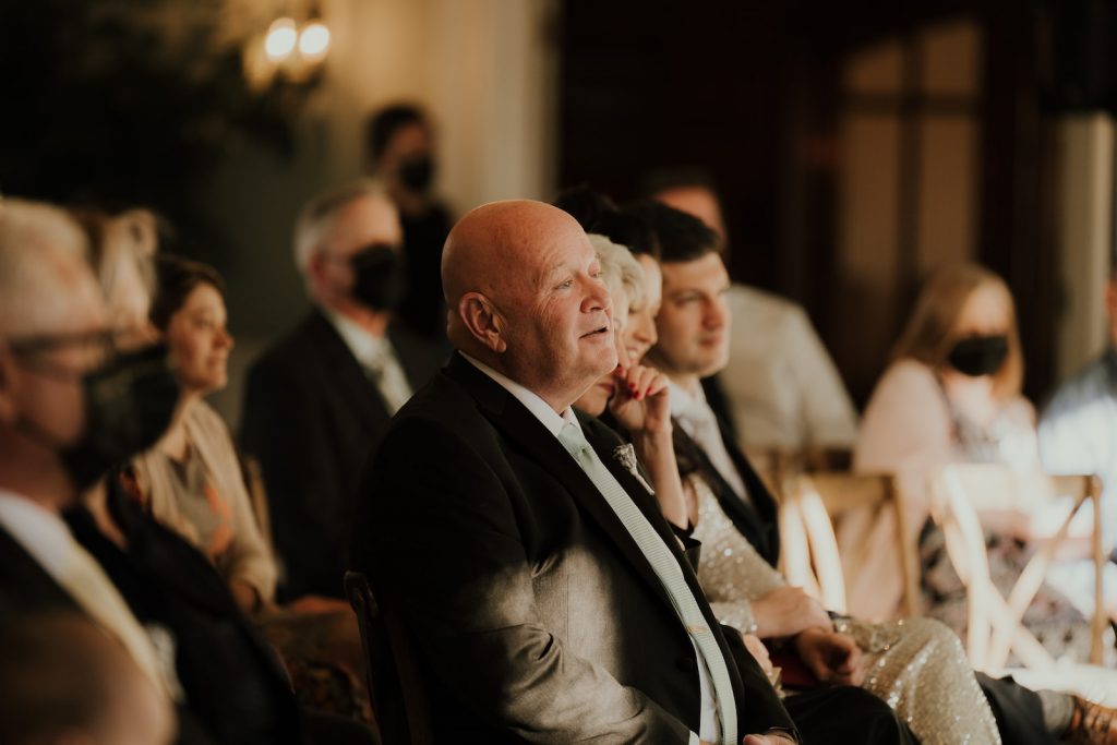 wedding photography candid shot of a proud father and teary mother