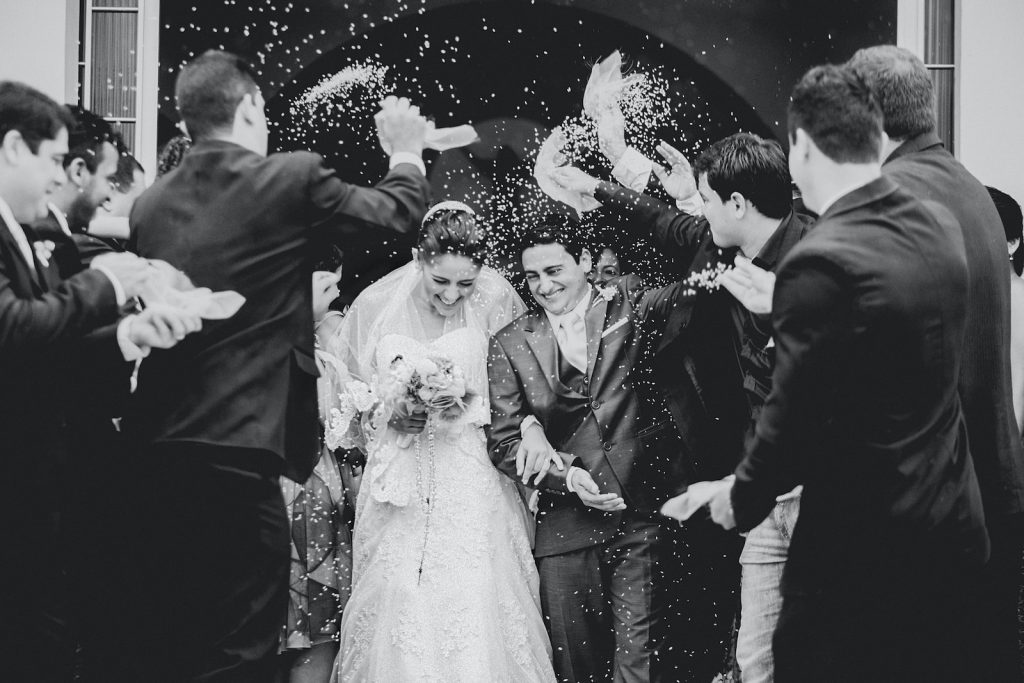 wedding photography of newly wed leaving the ceremony building