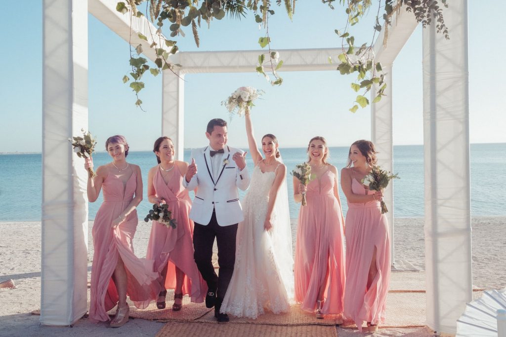 wedding photography bride and groom with bridesmaid at alter